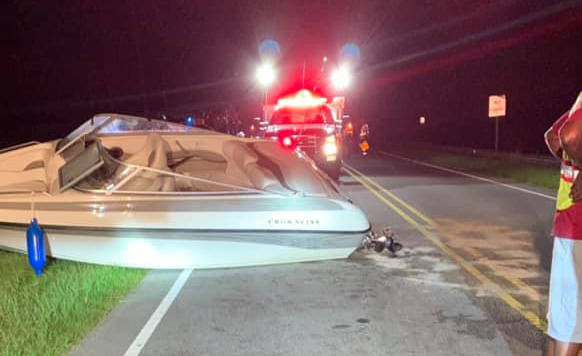The boat went over the guardrail10 feet up and landed in the far lane